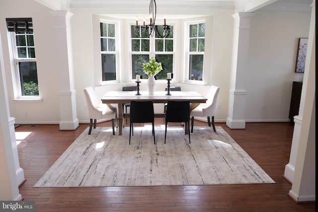 2725 Shelburne Rd, Downingtown, PA 19335 - dining area featuring wood-type flooring, ornate columns, crown molding, and an inviting chandelier