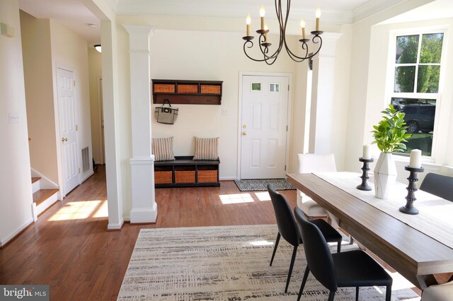 2725 Shelburne Rd, Downingtown, PA 19335 - dining area with a notable chandelier, baseboards, decorative columns, wood finished floors, and ornamental molding