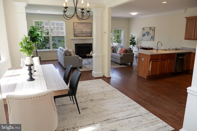 2725 Shelburne Rd, Downingtown, PA 19335 - dining space with dark wood-style flooring, crown molding, a fireplace, ornate columns, and recessed lighting