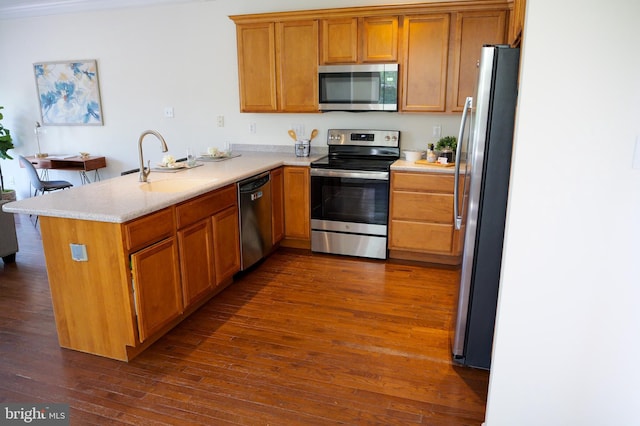 2725 Shelburne Rd, Downingtown, PA 19335 - kitchen with a peninsula, dark wood-type flooring, brown cabinets, a sink, and appliances with stainless steel finishes