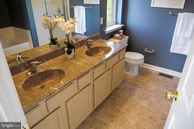 2725 Shelburne Rd, Downingtown, PA 19335 - full bathroom featuring toilet, visible vents, a tile shower, and a sink