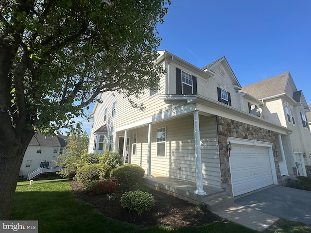 2725 Shelburne Rd, Downingtown, PA 19335 - view of side of home with a garage, driveway, covered porch, and stone siding
