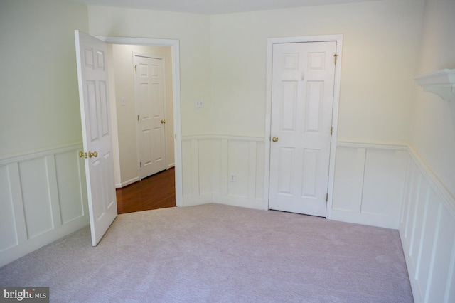 2725 Shelburne Rd, Downingtown, PA 19335 - unfurnished bedroom with carpet flooring, wainscoting, and a decorative wall