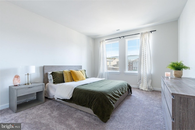 bedroom featuring baseboards, visible vents, and carpet