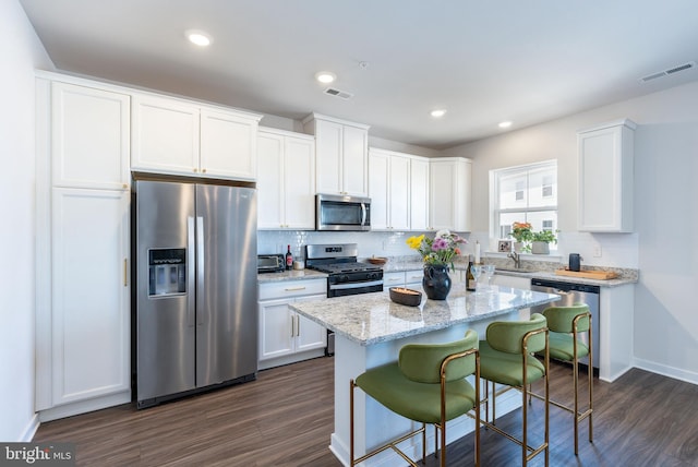 kitchen with visible vents, appliances with stainless steel finishes, and white cabinets