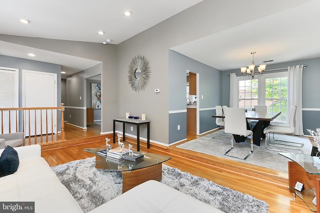 living room featuring baseboards, recessed lighting, wood finished floors, and a chandelier