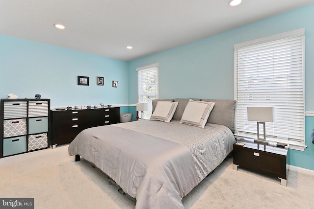 bedroom with light colored carpet, recessed lighting, and baseboards