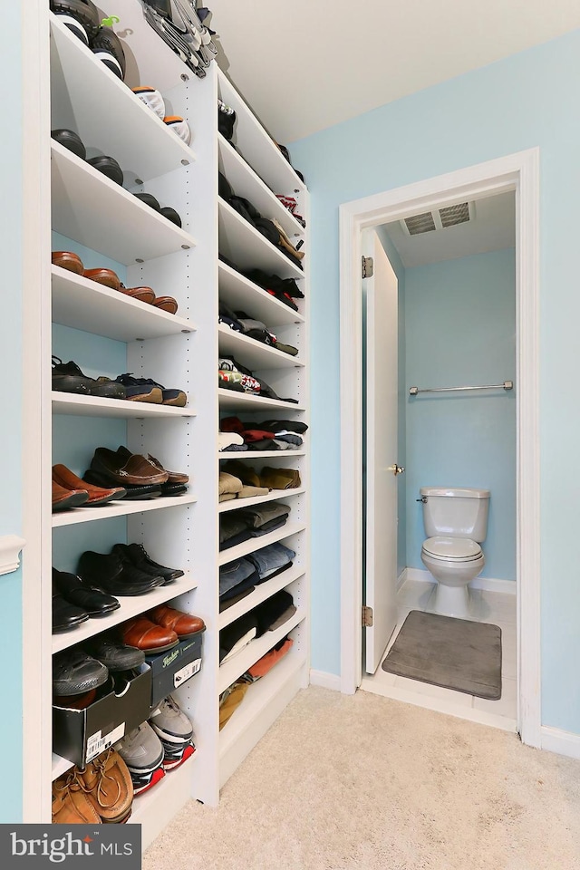 walk in closet with carpet floors and visible vents