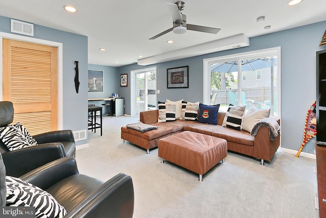 living area with recessed lighting, visible vents, and carpet