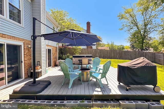 deck featuring outdoor dining area and a fenced backyard
