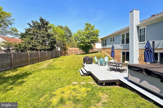 view of yard featuring outdoor dining area, a fenced backyard, a hot tub, and a deck