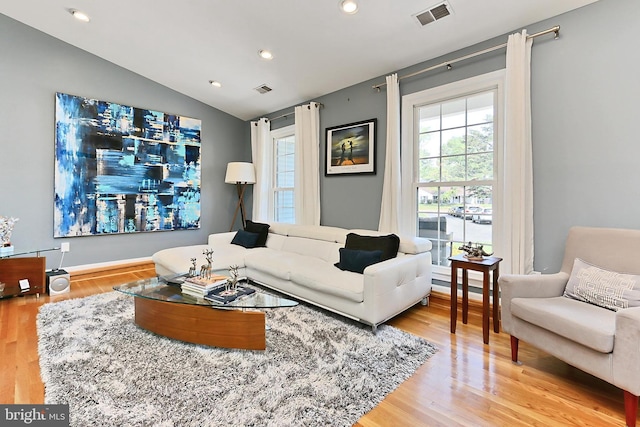 living area with visible vents, recessed lighting, wood finished floors, and vaulted ceiling