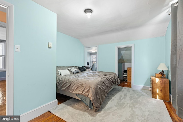 bedroom featuring baseboards and wood finished floors