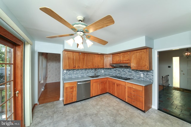 kitchen featuring brown cabinetry, decorative backsplash, under cabinet range hood, and dishwasher