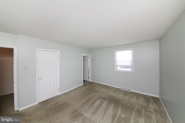 unfurnished bedroom featuring carpet flooring, baseboards, and visible vents