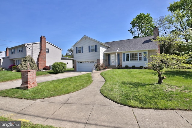 tri-level home featuring driveway, a garage, brick siding, a front lawn, and a shingled roof