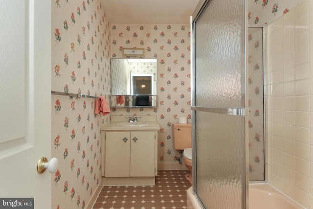 bathroom featuring a shower with shower door, vanity, toilet, wallpapered walls, and a tub to relax in