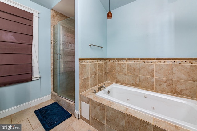 full bathroom featuring a jetted tub, baseboards, and a shower stall
