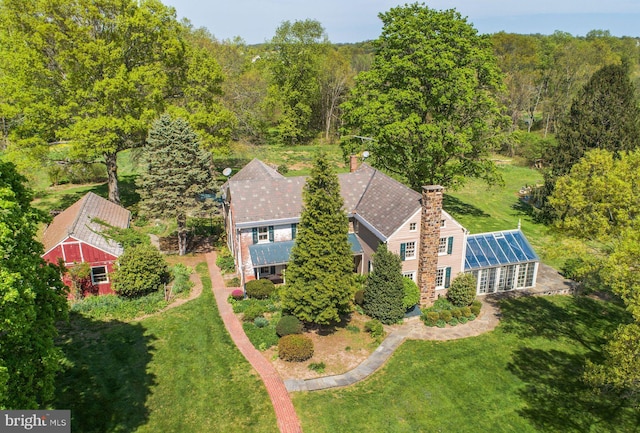 birds eye view of property with a forest view