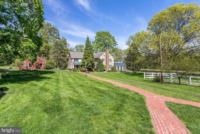 view of yard featuring fence and an outdoor structure