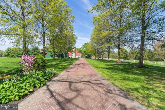 view of home's community featuring fence and a yard