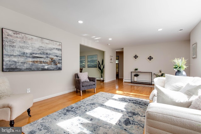 living room with visible vents, wood finished floors, baseboards, a baseboard radiator, and recessed lighting