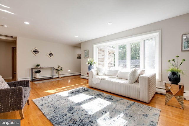 living room featuring light wood-type flooring, recessed lighting, baseboards, and baseboard heating