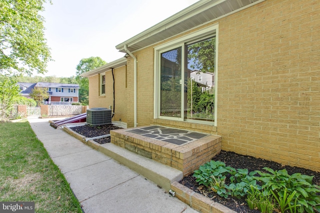 view of home's exterior with fence and cooling unit