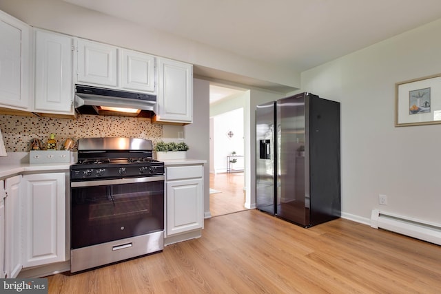 kitchen featuring light countertops, stainless steel appliances, white cabinetry, light wood-type flooring, and under cabinet range hood