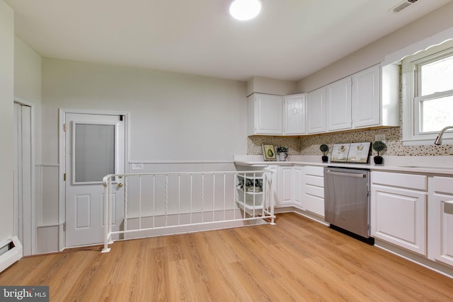 kitchen with a sink, white cabinets, stainless steel dishwasher, and light wood-style flooring