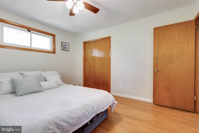 bedroom featuring a closet, baseboards, ceiling fan, and light wood-type flooring