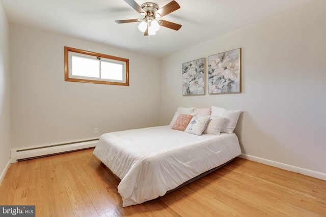 bedroom with baseboards, light wood-style flooring, ceiling fan, and baseboard heating