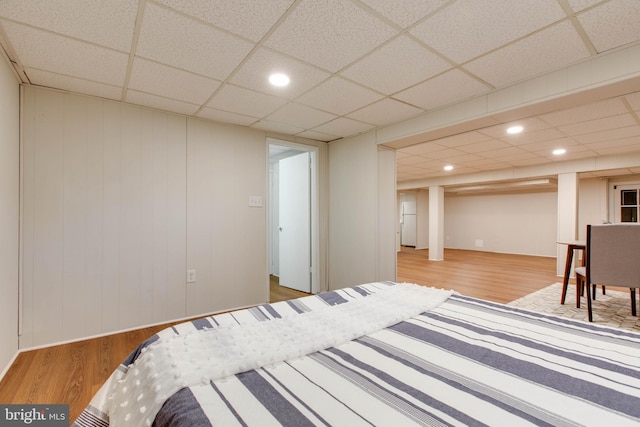 bedroom featuring a paneled ceiling, recessed lighting, and wood finished floors