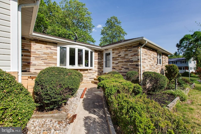 doorway to property with stone siding