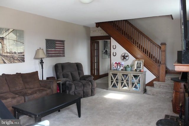 living area with stairs and carpet flooring