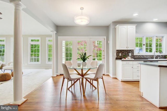 7820 Elsinore Dr, Manassas, VA 20112 - dining area featuring recessed lighting, baseboards, decorative columns, and light wood finished floors