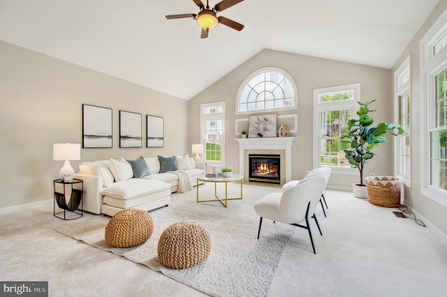 7820 Elsinore Dr, Manassas, VA 20112 - carpeted living room with baseboards, a glass covered fireplace, ceiling fan, and vaulted ceiling