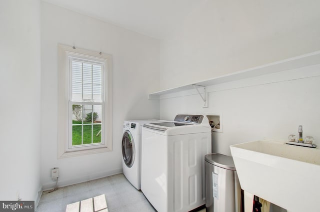 7820 Elsinore Dr, Manassas, VA 20112 - laundry room featuring laundry area, a sink, light floors, and separate washer and dryer