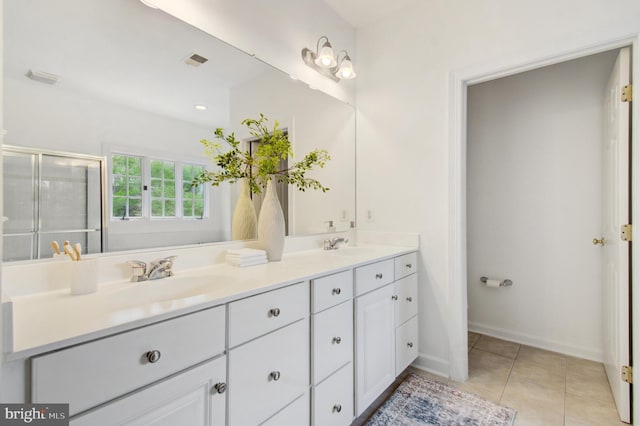7820 Elsinore Dr, Manassas, VA 20112 - full bath with a sink, double vanity, tile patterned floors, visible vents, and a stall shower