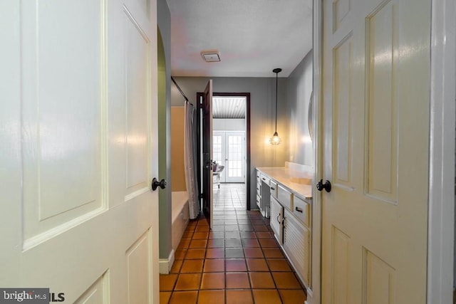 full bathroom featuring shower / tub combo with curtain, tile patterned floors, and vanity