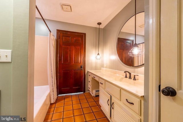 full bathroom with a baseboard heating unit, tile patterned floors, and vanity