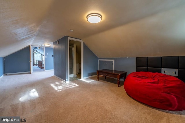 additional living space featuring carpet floors, vaulted ceiling, and baseboards