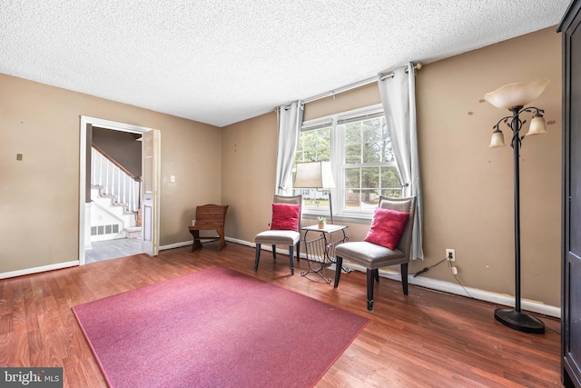 1713 Emerson Ave, Salisbury, MD 21801 - sitting room featuring stairs, a textured ceiling, wood finished floors, and baseboards