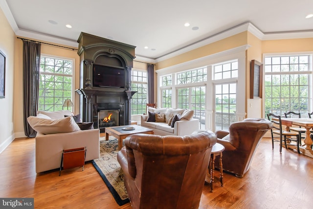 living room featuring a large fireplace, baseboards, recessed lighting, ornamental molding, and wood finished floors