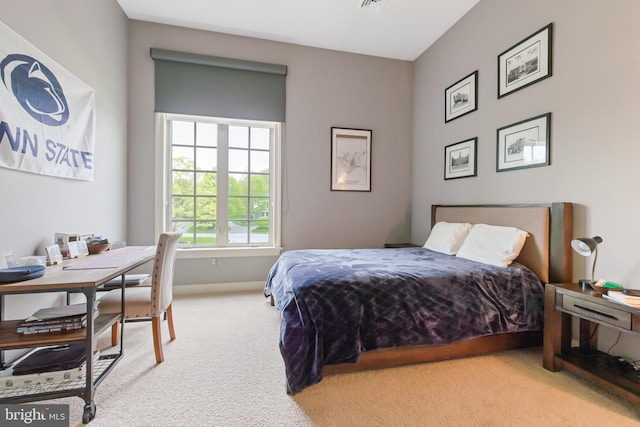 bedroom featuring baseboards, visible vents, and carpet flooring