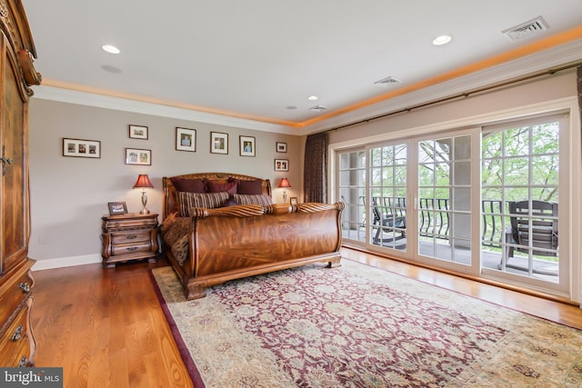 bedroom with recessed lighting, access to outside, visible vents, ornamental molding, and wood finished floors