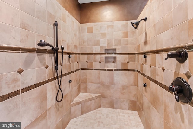 full bath featuring tiled shower
