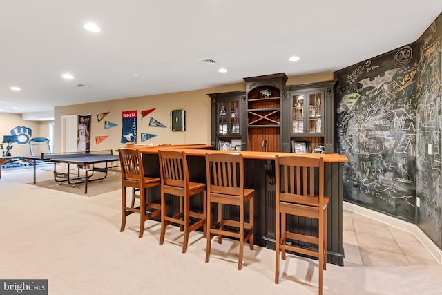 bar featuring visible vents, recessed lighting, a bar, and a sink