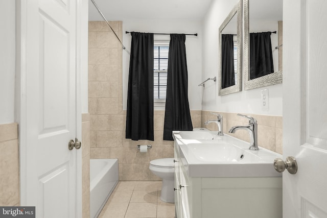 2124 Weber Dr, District Heights, MD 20747 - full bathroom featuring tile patterned floors, wainscoting, vanity, tile walls, and toilet