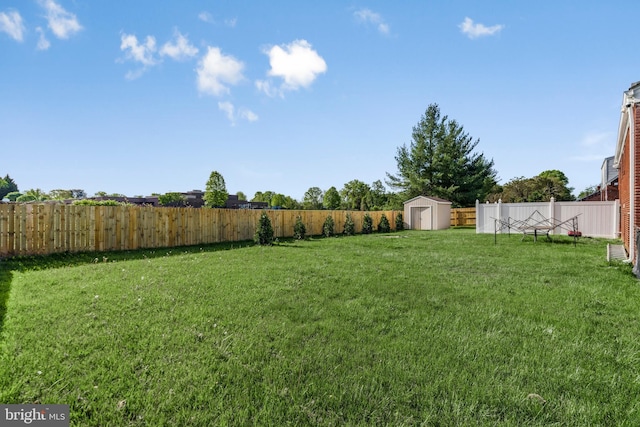 2124 Weber Dr, District Heights, MD 20747 - view of yard featuring a fenced backyard, a storage unit, and an outdoor structure